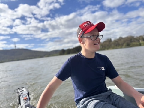 Jack smiling while out on a boat